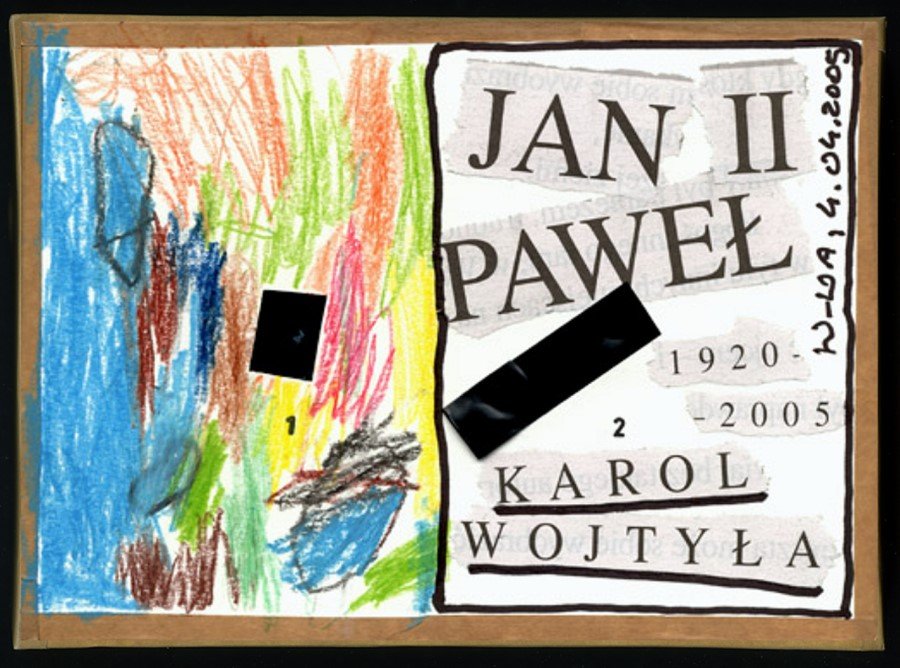 Front of a cardboard camera edged in brown paper tape: on the left a crayon drawing in blue, green, red and yellow, on the right a collage of newspaper cuttings reading Jan Paweł II, 1920 to 2005, Karol Wojtyła. A strip of black tape covers the pierced hole on each half, with a small 1 and a small 2 beside them.