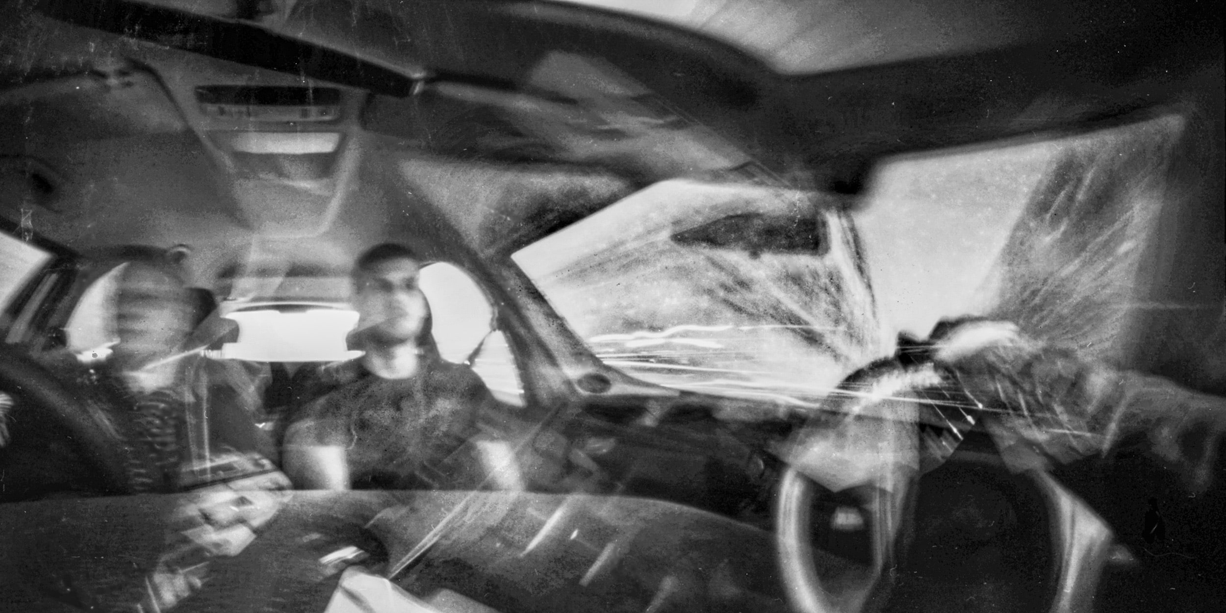 Pinhole photograph: a view from inside a car, black and white