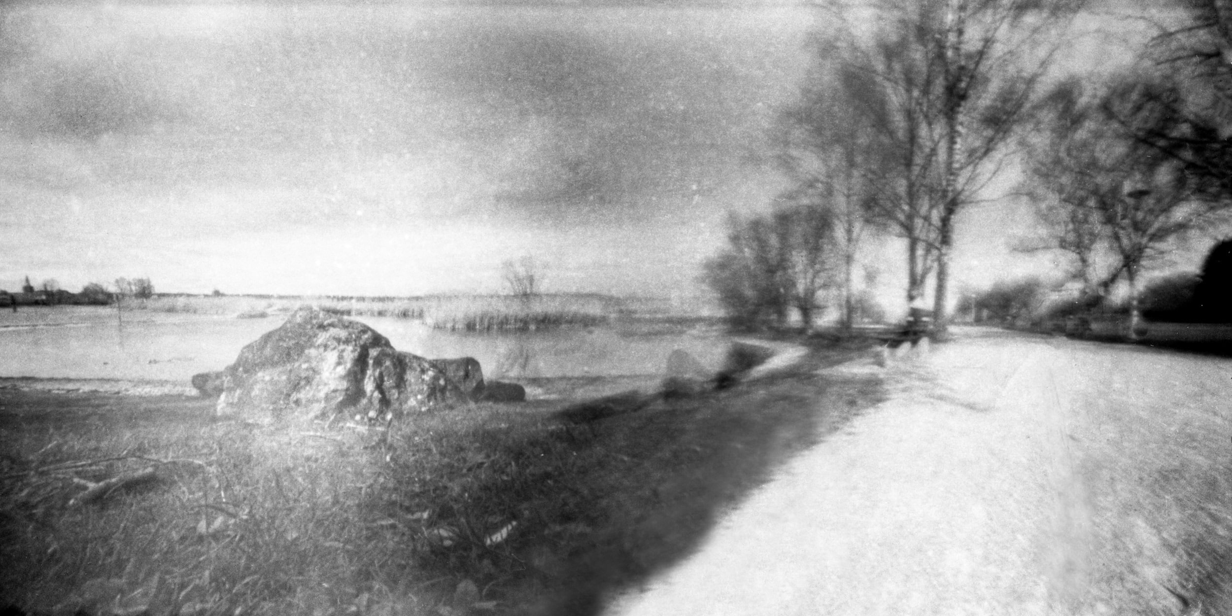 Pinhole photograph: a path through a field, black and white