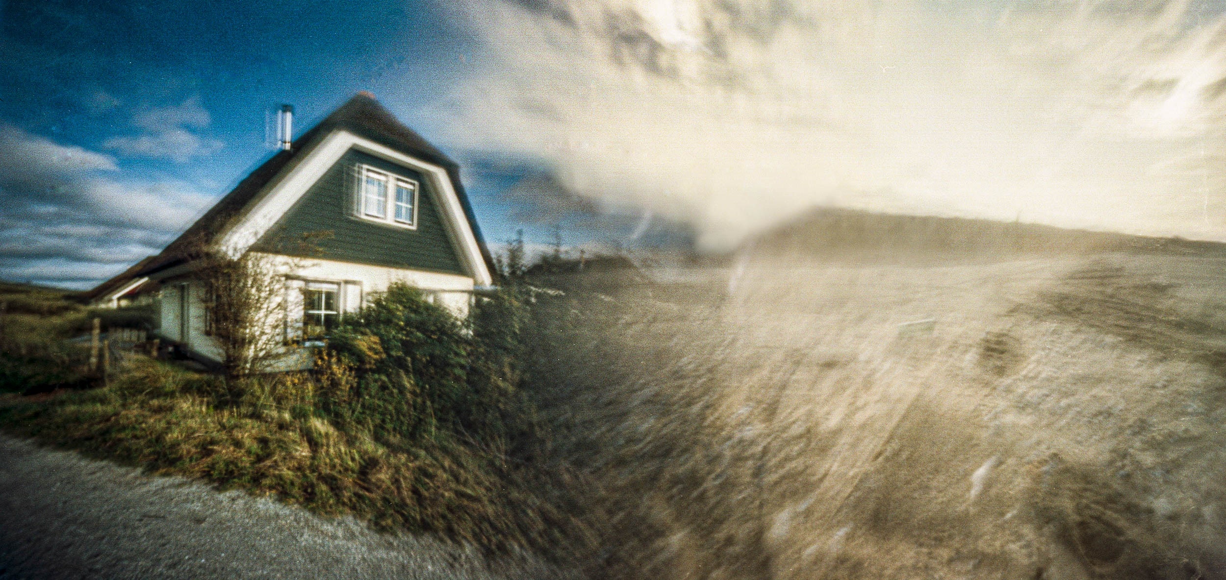 Pinhole photograph: a house at the edge of a dune
