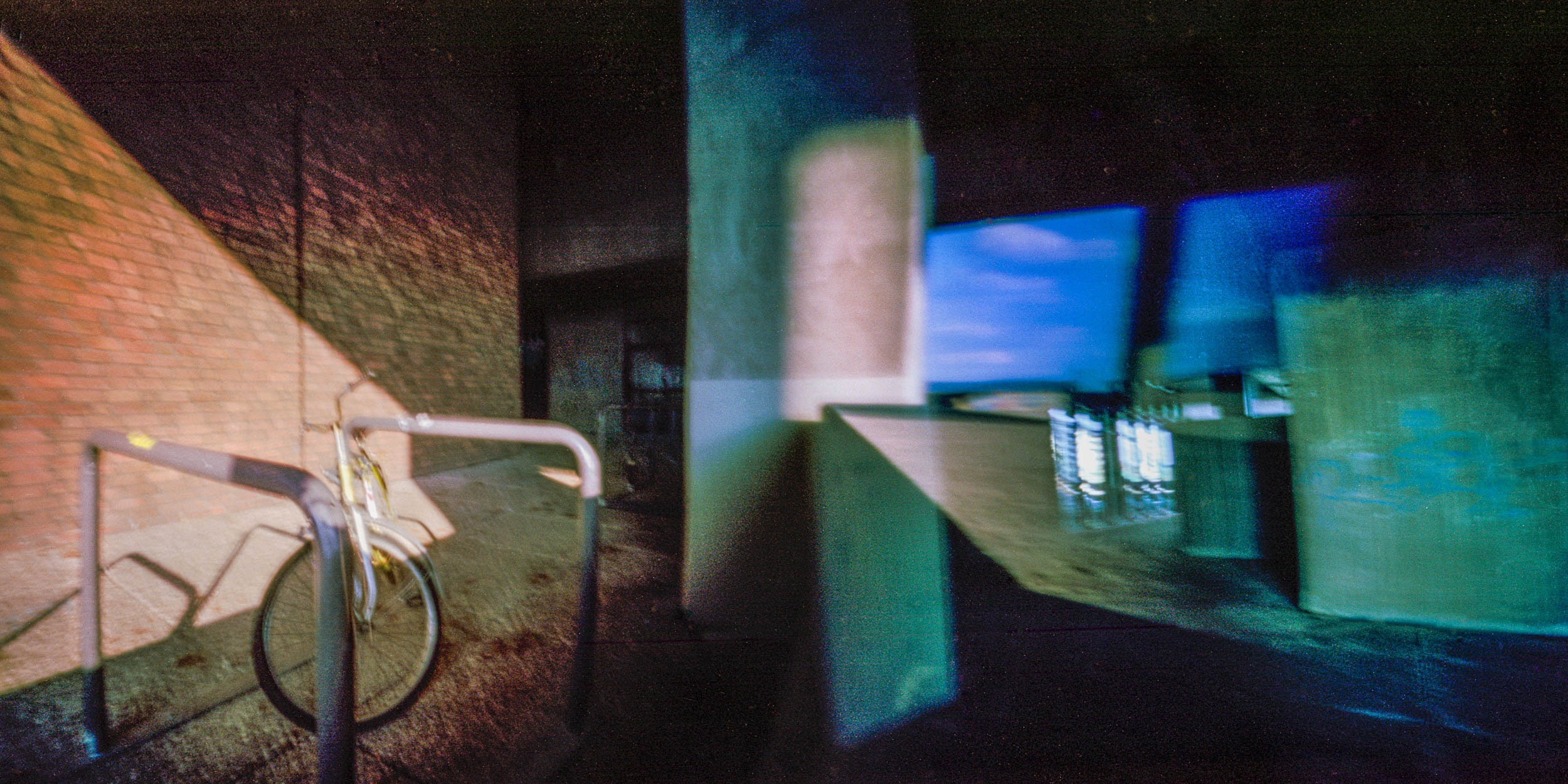 Pinhole photograph: an interior in red and blue, strongly distorted