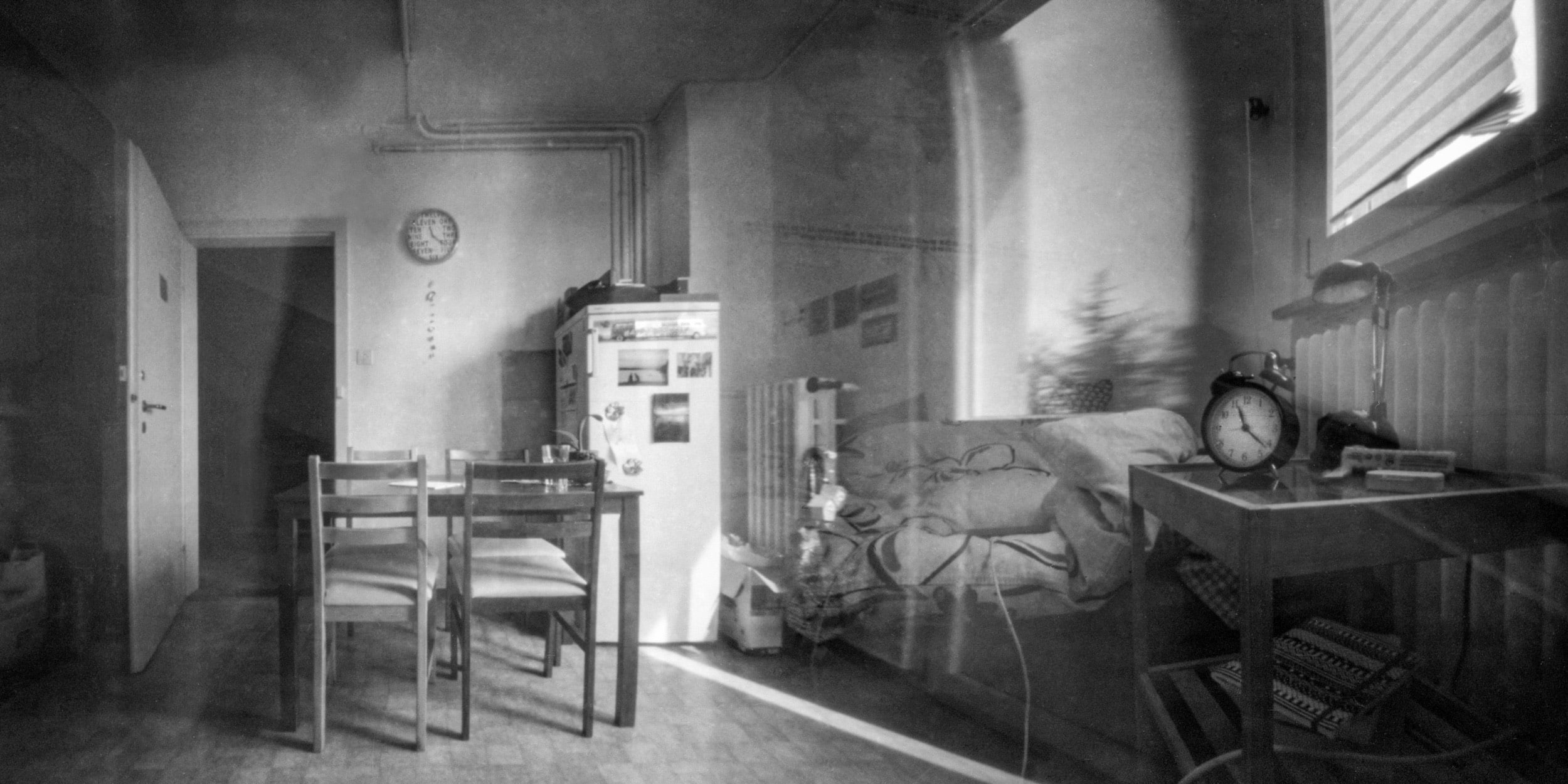 Pinhole photograph: an empty room with chairs and a clock